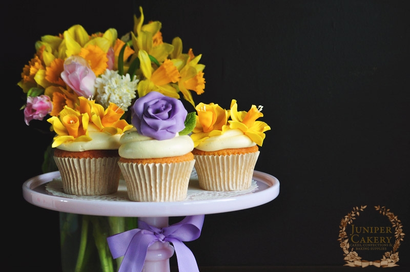 Cupcakes topped with gum paste daffodils and roses by Juniper Cakery