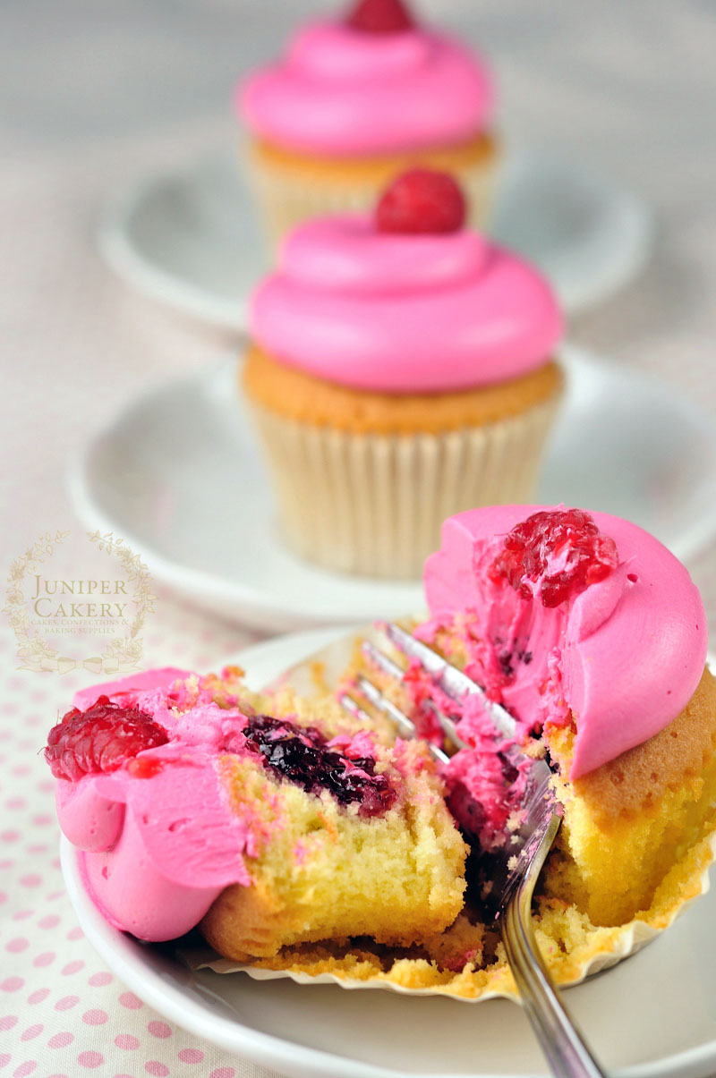 Raspberry cupcakes in a row by Juniper Cakery