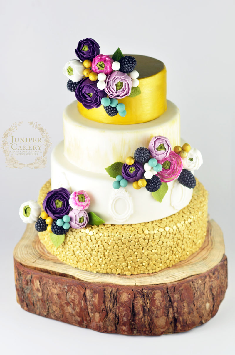 Amazing gold and purple ranunculus wedding cake by Juniper Cakery