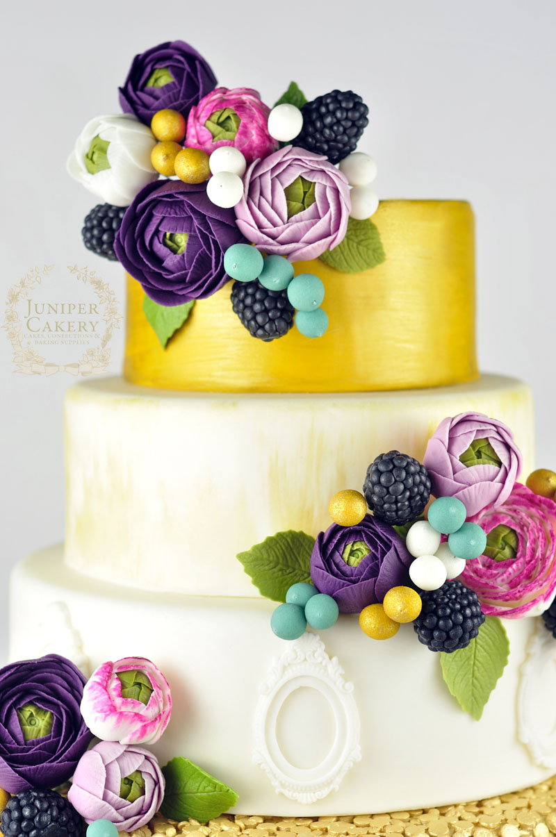 Gold and Purple ranunculus flower wedding cake by Juniper Cakery