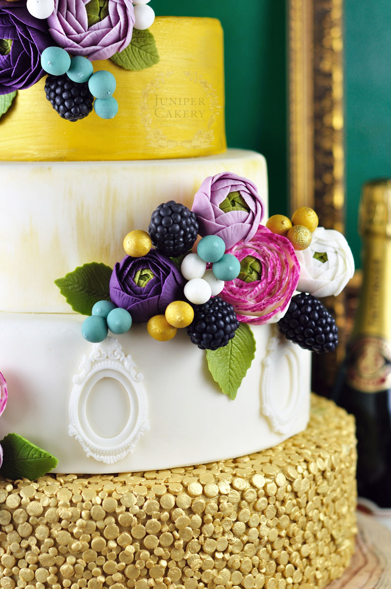 Lovely gold, pink and purple ranunculus cake by Juniper Cakery