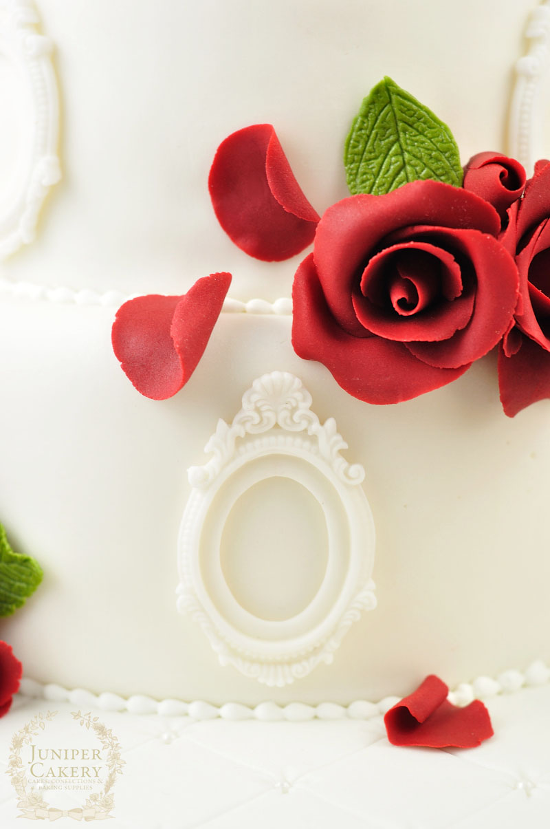 Red rose wedding cake with ornate frame detail by Juniper Cakery