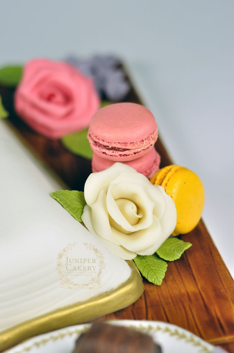 Recipe book cake with macarons and roses by Juniper Cakery