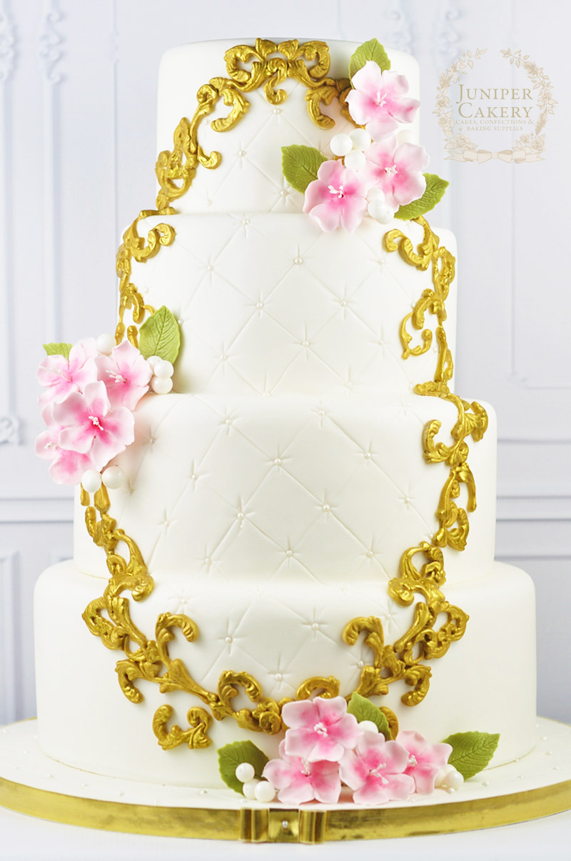 Sweet cherry blossom wedding cake with gold painted frame by Juniper Cakery