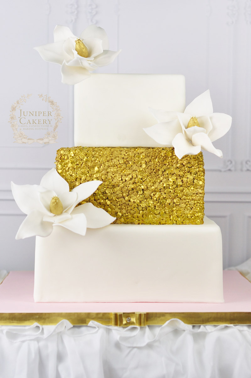 Gilded sequin and magnolia flower wedding cake by Juniper Cakery