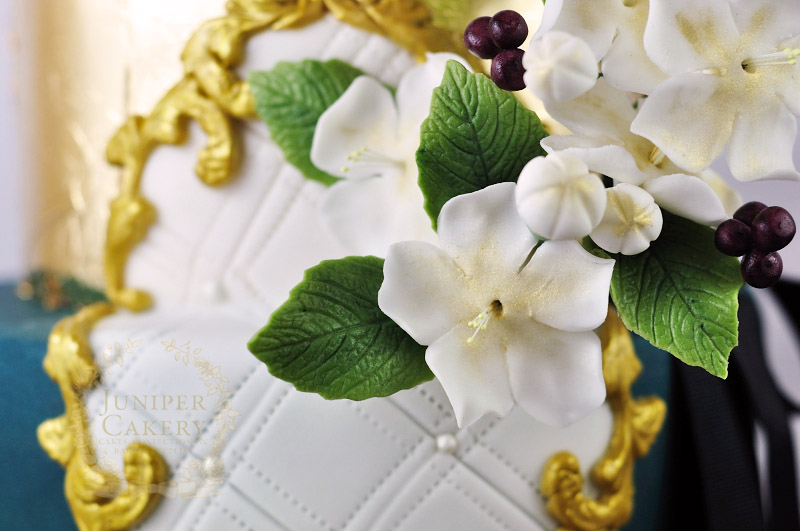 Sugar flowers on ornate wedding cake by Juniper Cakery