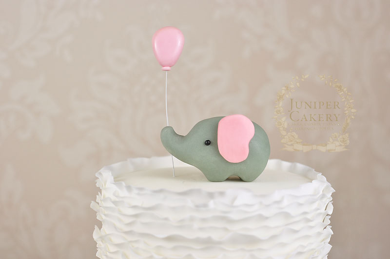 Ruffled baby shower cake with gum paste elephant by Juniper Cakery