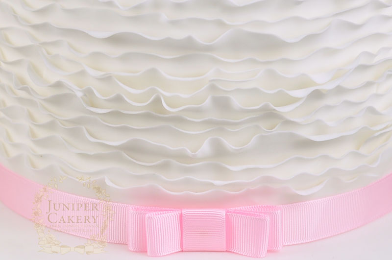 Fondant ruffles on a cake by Juniper Cakery