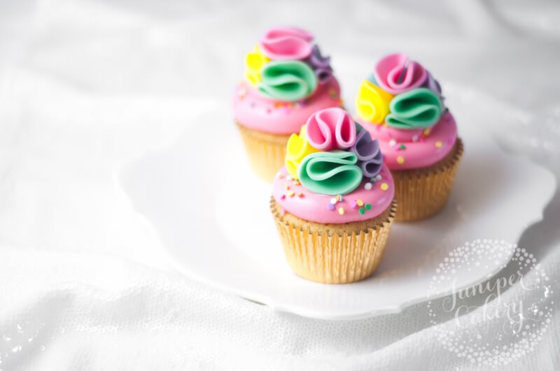 Rainbow pom pom cupcakes by Juniper Cakery