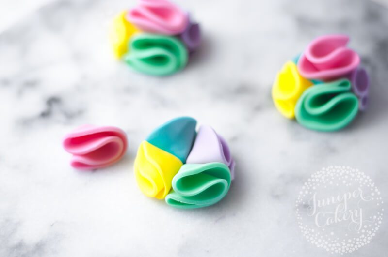 Edible fondant rainbow pom pom cupcakes by Juniper Cakery