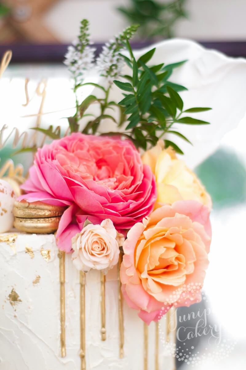 Gold sequin drip wedding cake with macarons and roses by Juniper Cakery