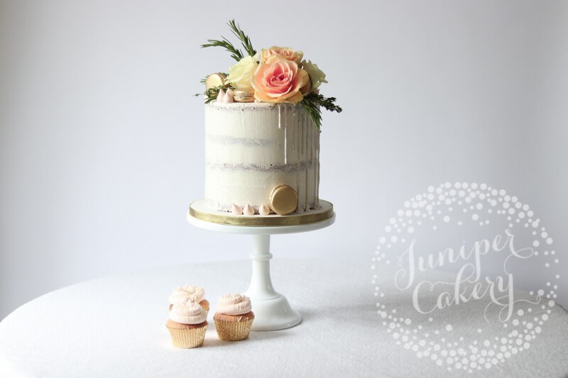 White semi-naked cake with white shimmer sequin drip by Juniper Cakery